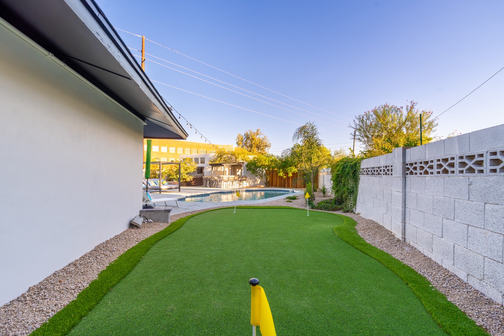The property features a private putting green with sparkling pool, perfect for outdoor recreation and relaxation under warm Arizona skies.