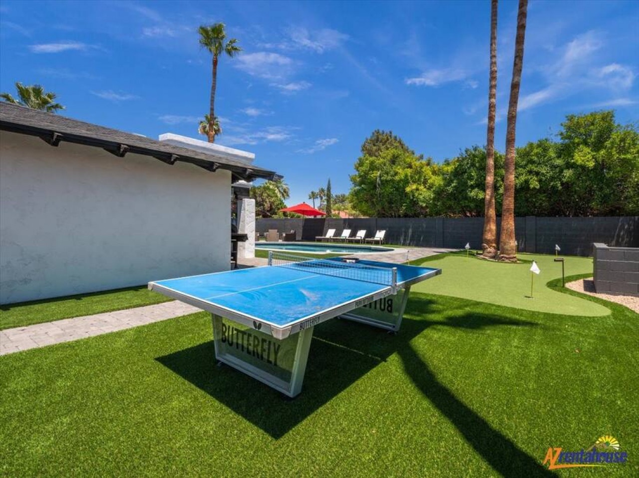 Challenge friends to ping pong on your private lawn while soaking up sunshine by the sparkling pool in this resort-style backyard paradise.