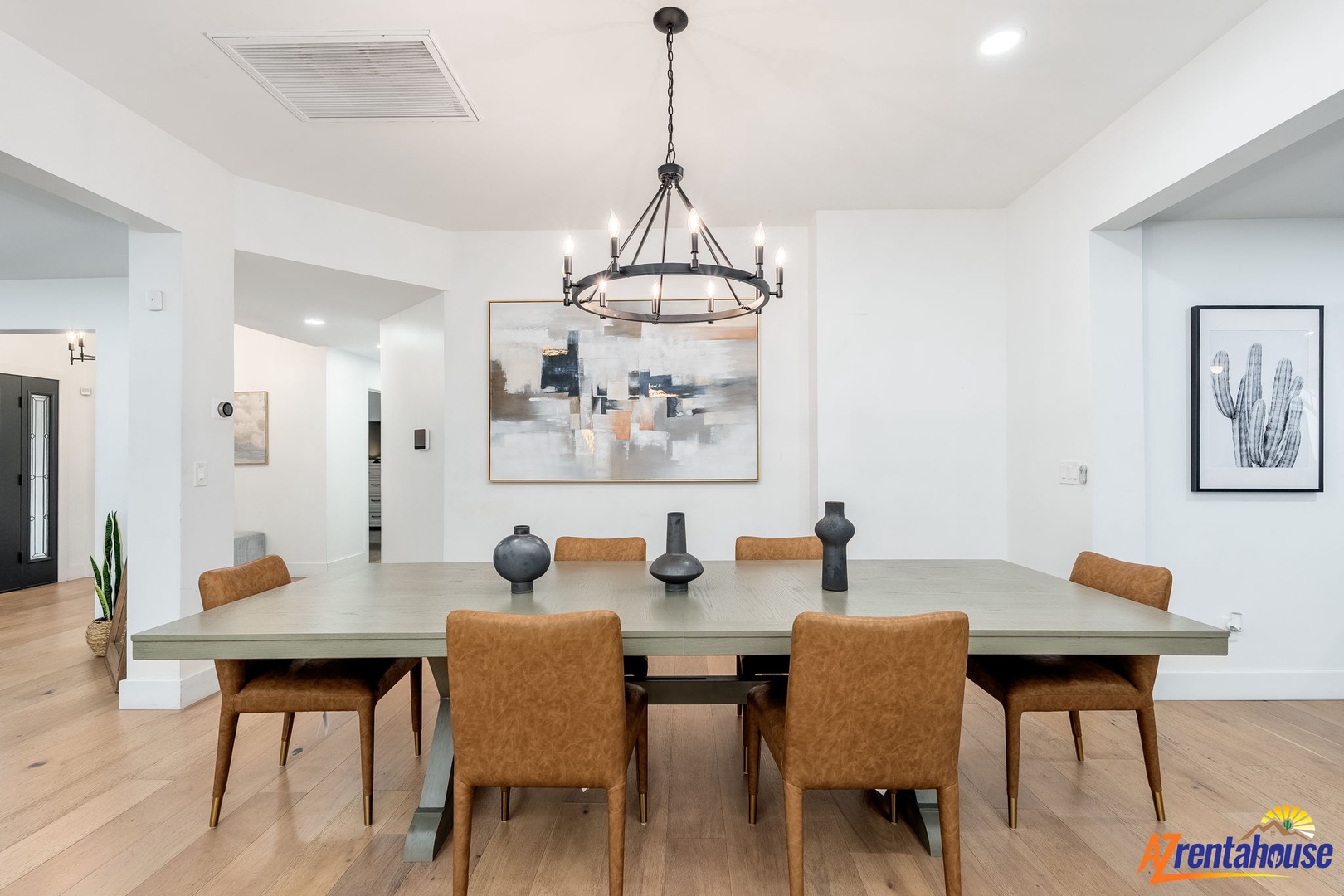 Gather around this stunning dining table where memorable meals and conversations unfold beneath elegant lighting in your spacious, modern dining room.