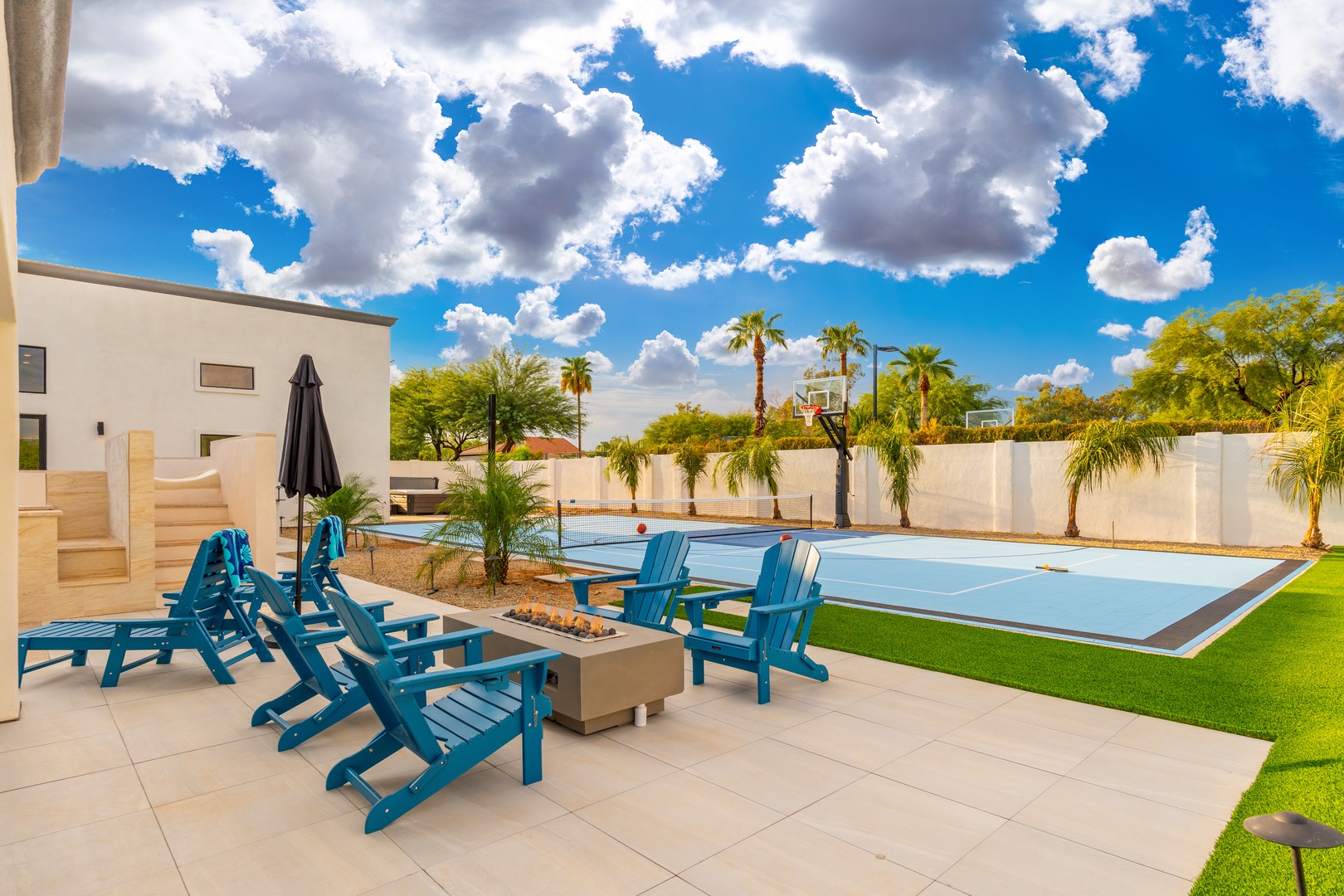 Settle into vibrant Adirondack chairs by your private pool and soak up the Arizona sun. Palm trees sway overhead as you unwind on this expansive patio, perfect for morning coffee or evening lounging.