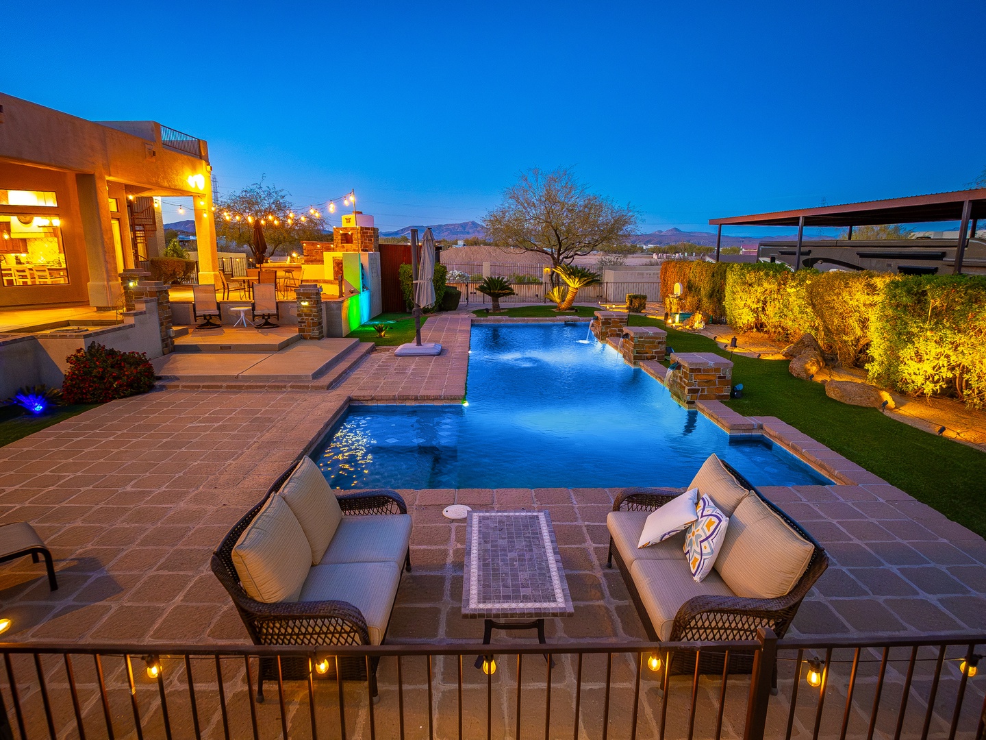 Your private backyard oasis awaits with a sparkling pool, cozy lounge seating, and elegant landscape lighting that creates the perfect ambiance for evening relaxation under the stars.