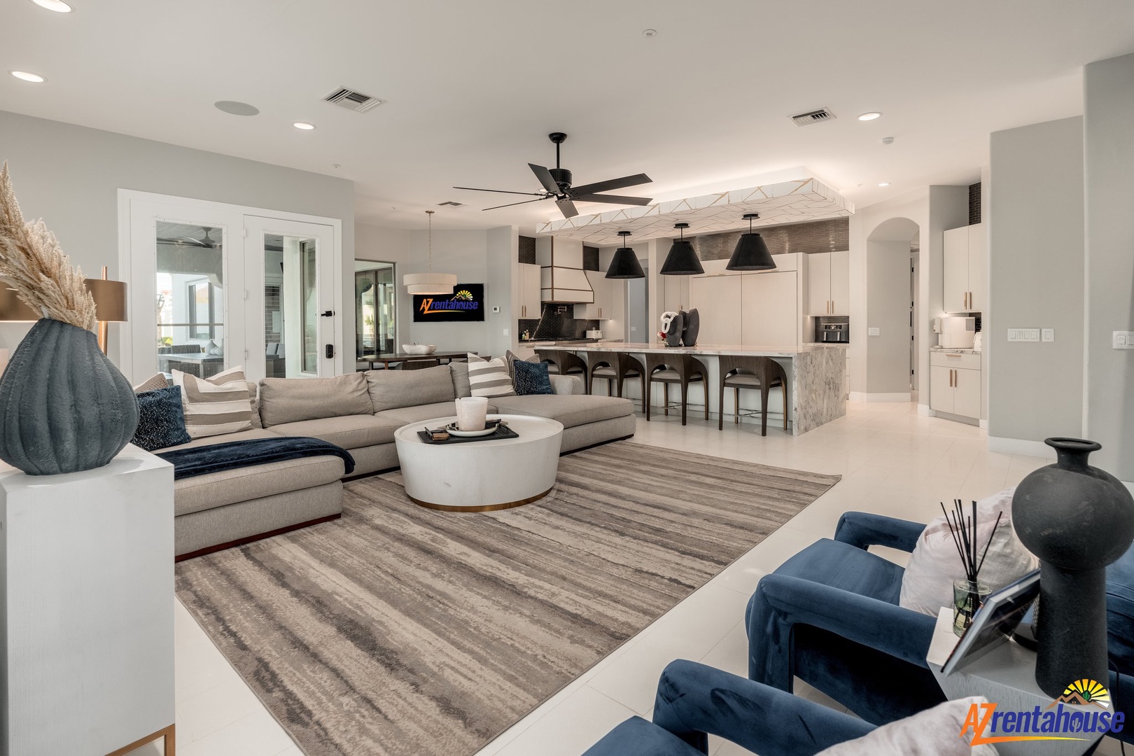Unwind in your spacious open-concept living area where modern comfort meets elegant design, complete with plush seating and a gourmet kitchen.