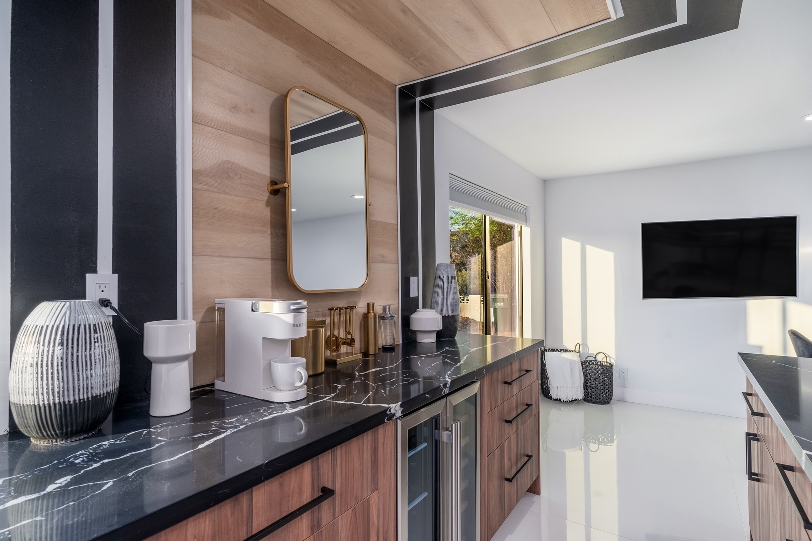 Sleek marble countertops and warm wood accents create your perfect morning routine, with stylish details and modern comfort throughout this inviting space.