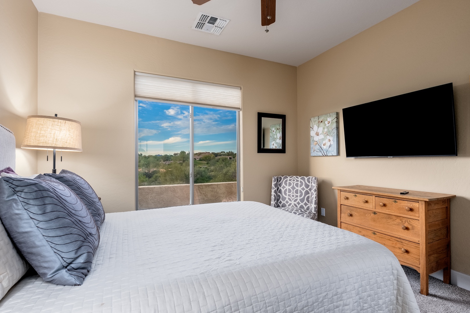Drift off in this serene bedroom where soft linens meet desert vistas, your private retreat framed by natural light and thoughtful comforts.