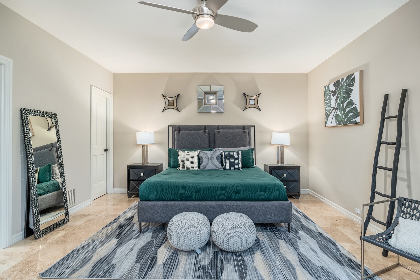 Settle into your serene retreat with plush bedding, modern décor, and thoughtful touches—ceiling fan for comfort, generous mirrors, and a calming palette that invites restful nights.