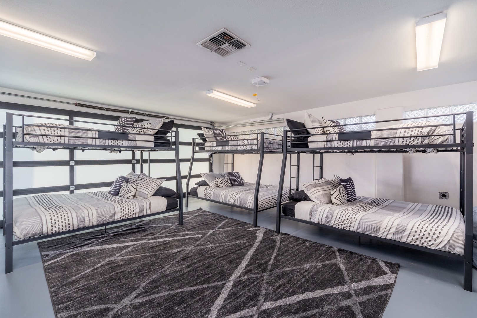 Perfect for family getaways or group trips, this spacious room features multiple bunk beds with cozy bedding. Clean, modern, and thoughtfully designed to keep everyone comfortable after a day of adventure.