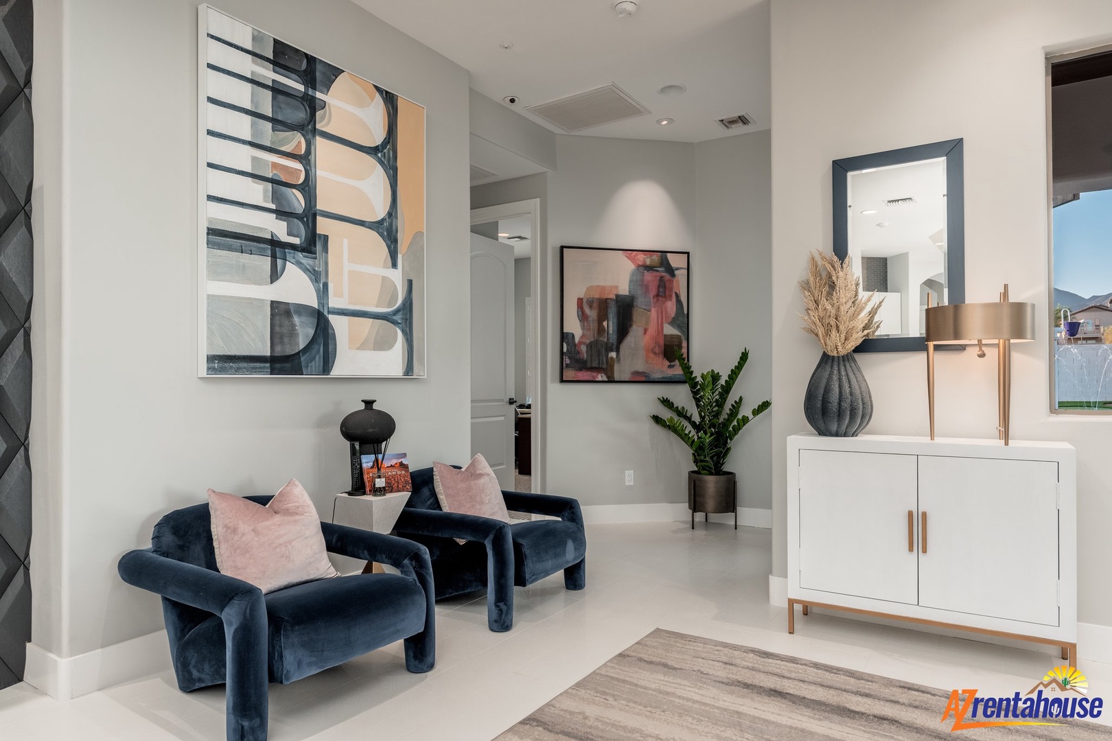 Settle into plush navy velvet chairs surrounded by contemporary art and thoughtful design touches that make this space feel effortlessly sophisticated.