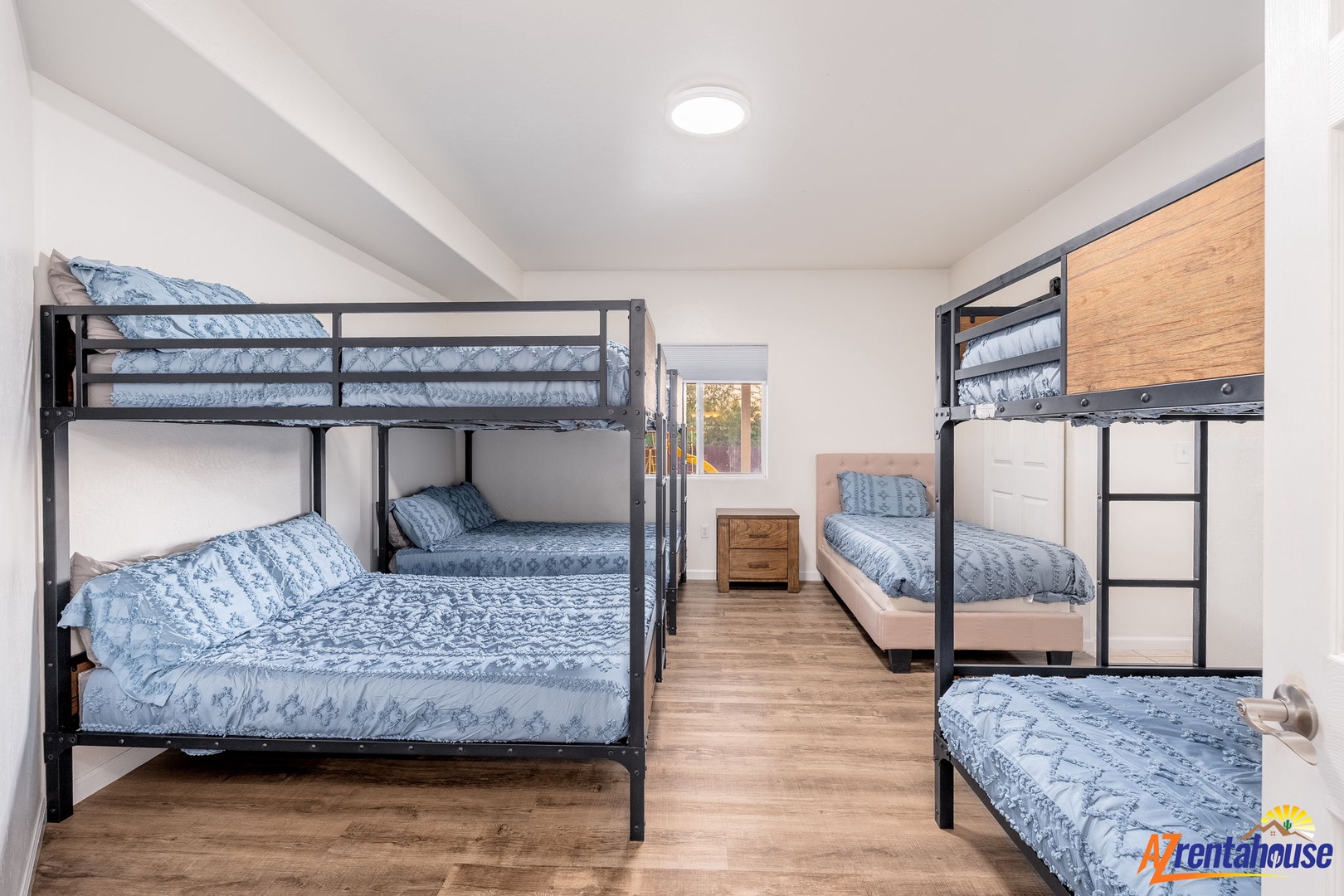 Two sturdy bunk beds offer flexible sleeping for your group, with warm wood floors and natural light inviting restful stays for everyone.