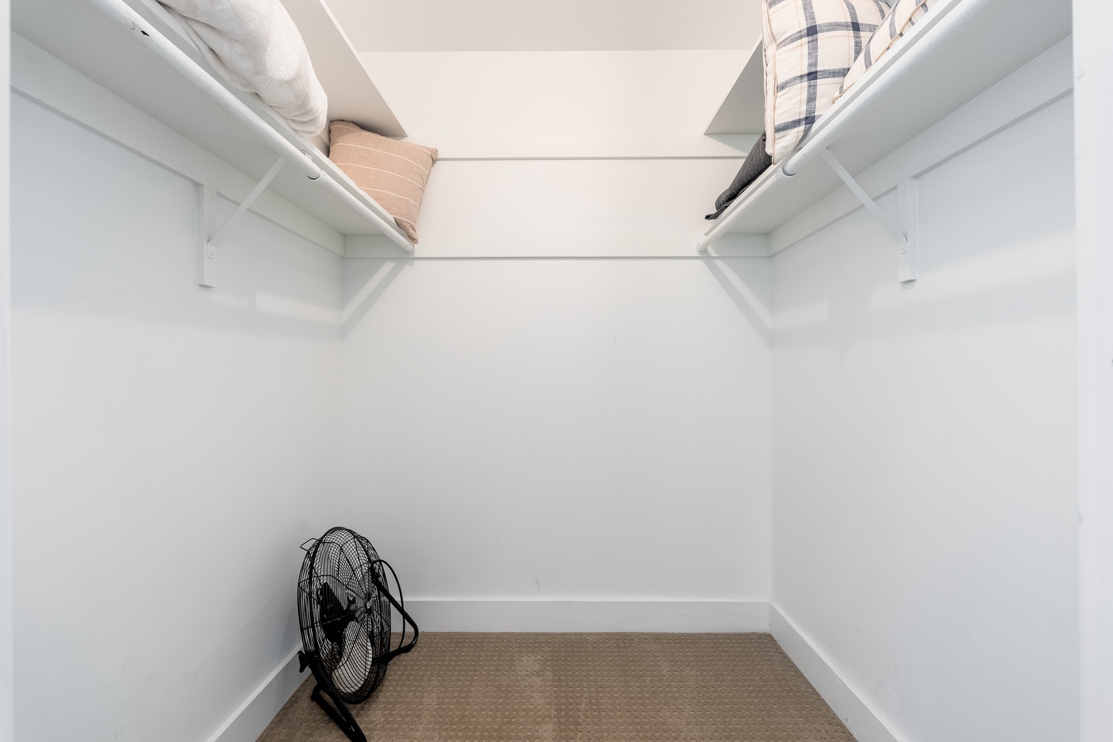 A spacious walk-in closet with convenient shelving and room to organize your belongings, keeping your space tidy and stress-free during your stay.