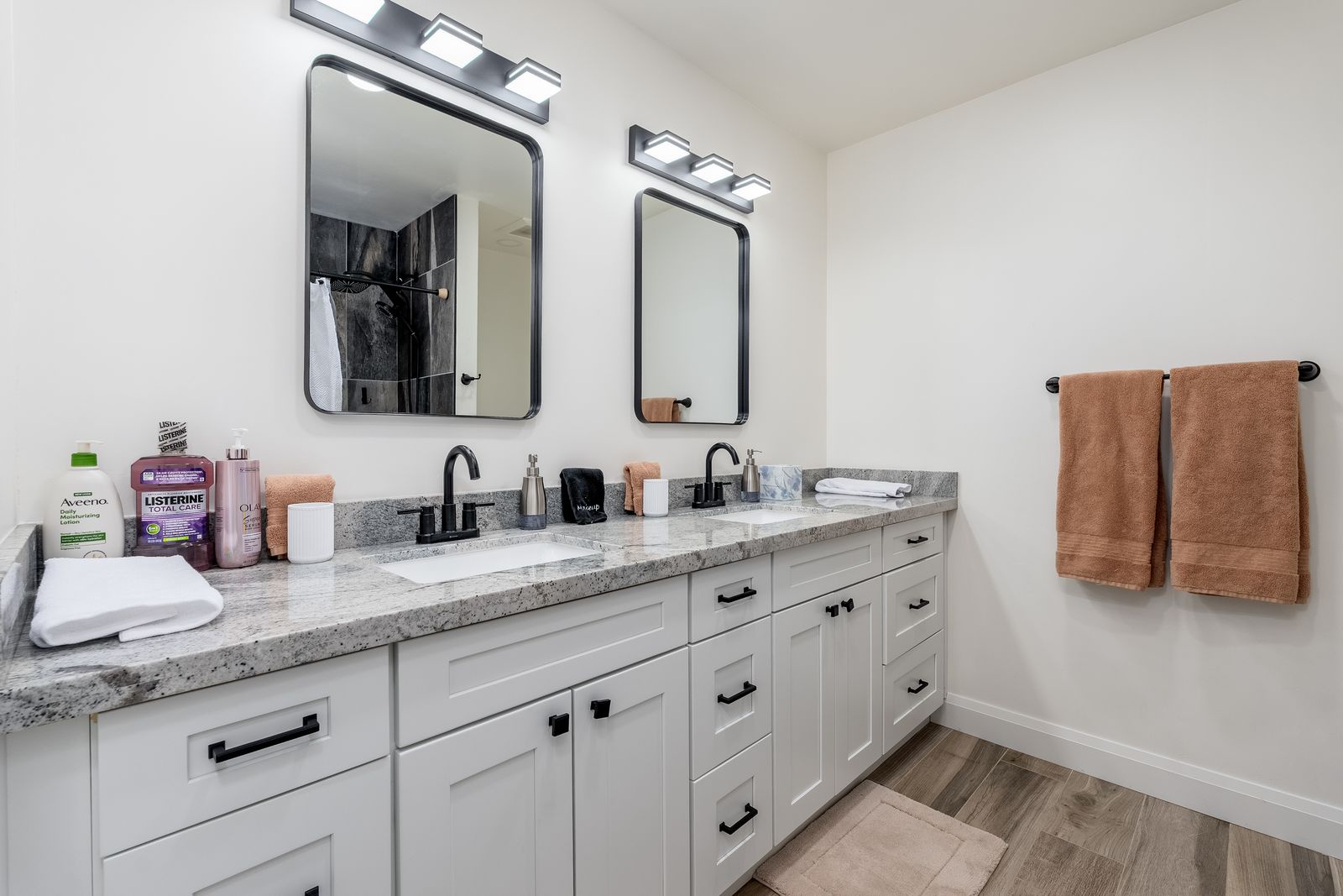 Freshly updated vanity with modern fixtures, stylish mirrors, and plush towels—your personal oasis awaits. Everything you need for a relaxing, refreshing stay.