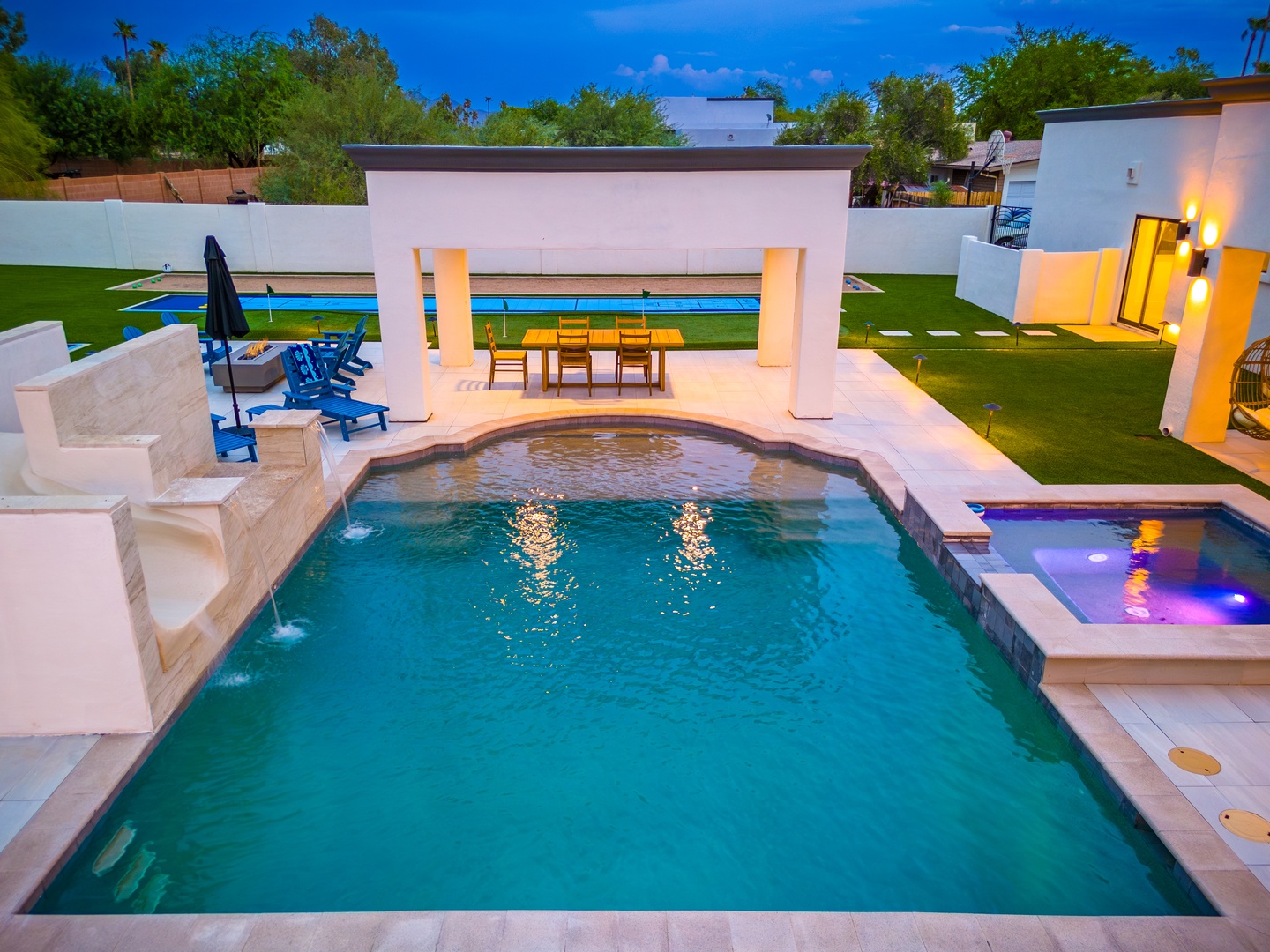Modern desert oasis with heated pool, spa, covered dining pavilion, and vibrant blue skies—your private retreat awaits for ultimate relaxation and outdoor entertaining.