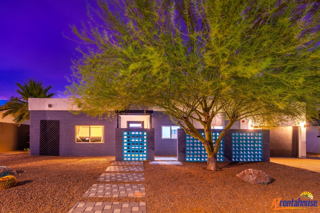 Modern desert retreat with striking architecture and dramatic twilight lighting creates an unforgettable arrival experience.
