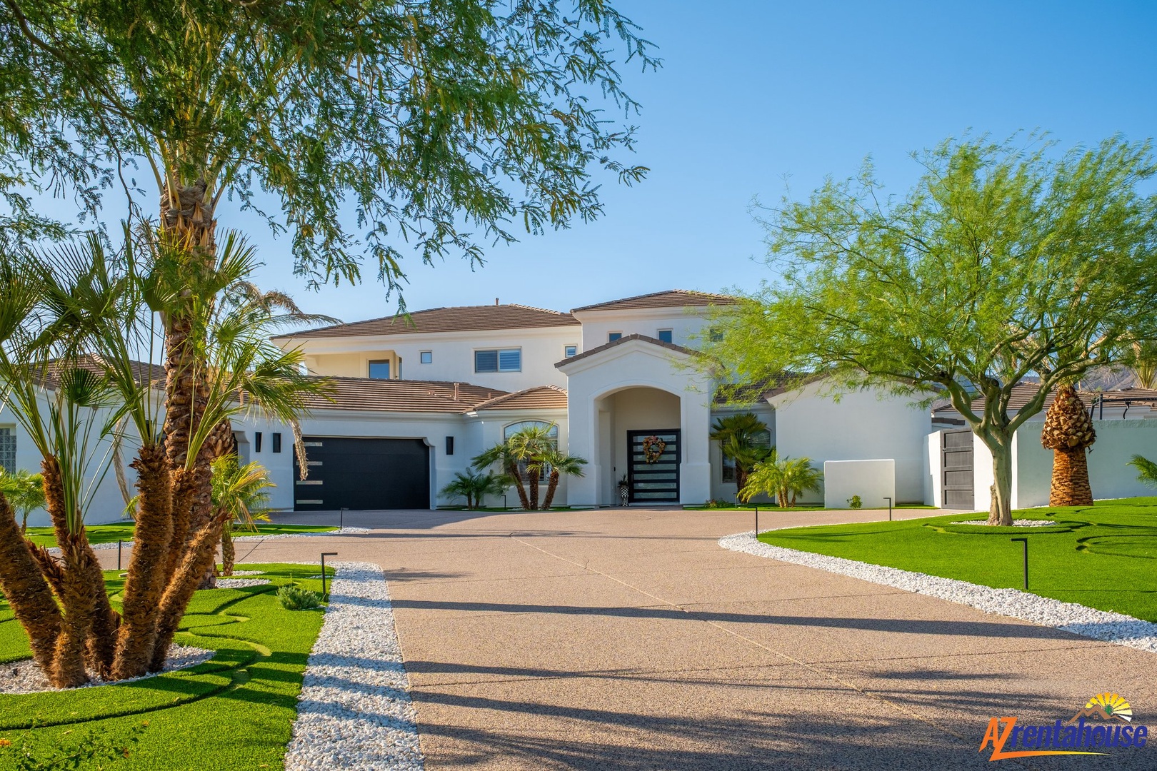 A stunning modern villa with elegant architecture set amid lush tropical landscaping and manicured lawns in an upscale neighborhood.
