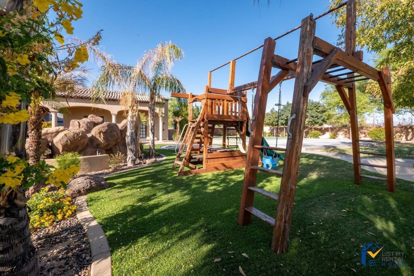 Your kids will love the adventure-ready playground in your private backyard, complete with swings and climbing structures on lush green grass.