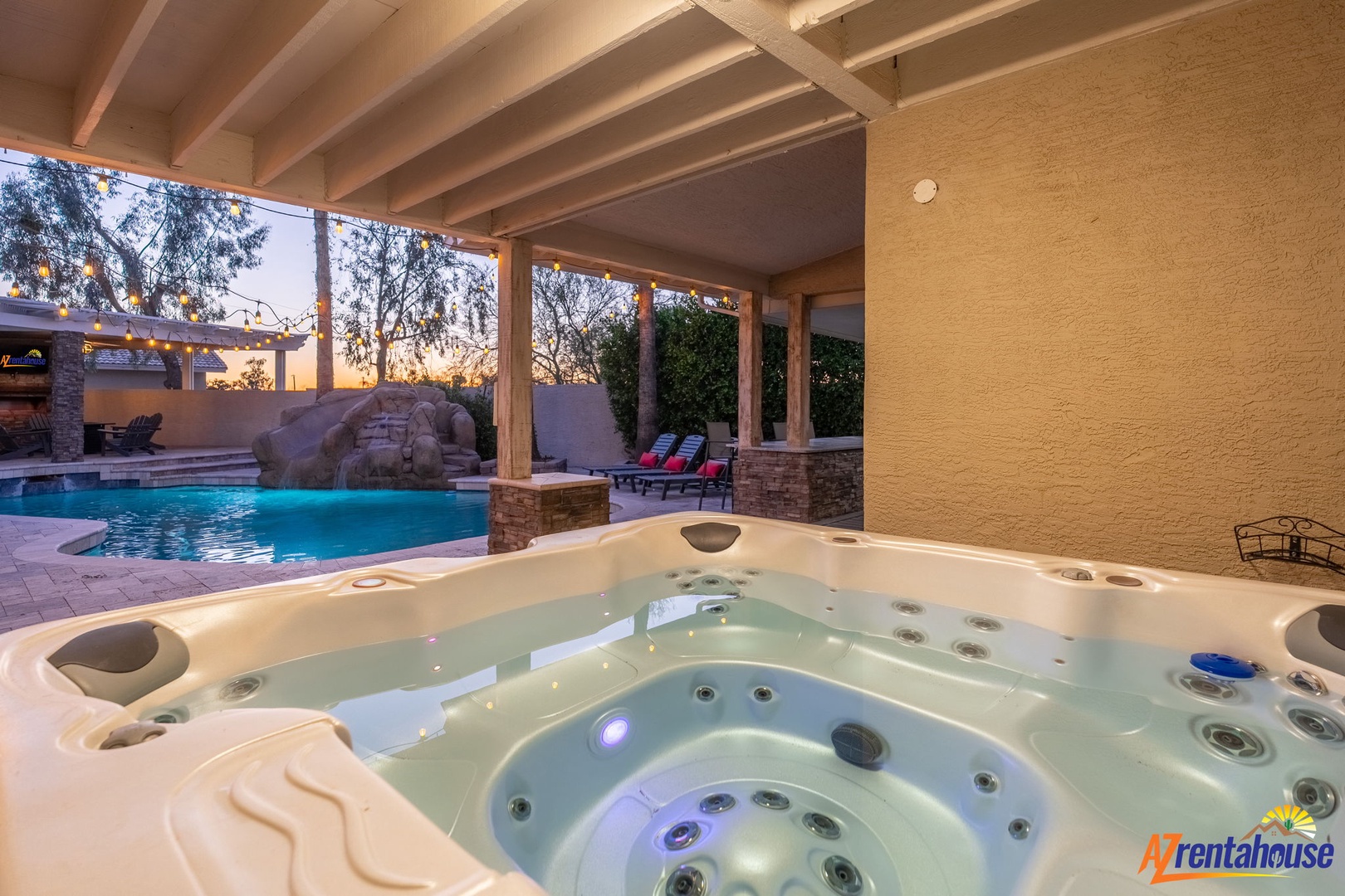 Slip into the bubbling hot tub and let your worries melt away as you gaze at the sparkling pool and desert sunset framed by the covered patio.