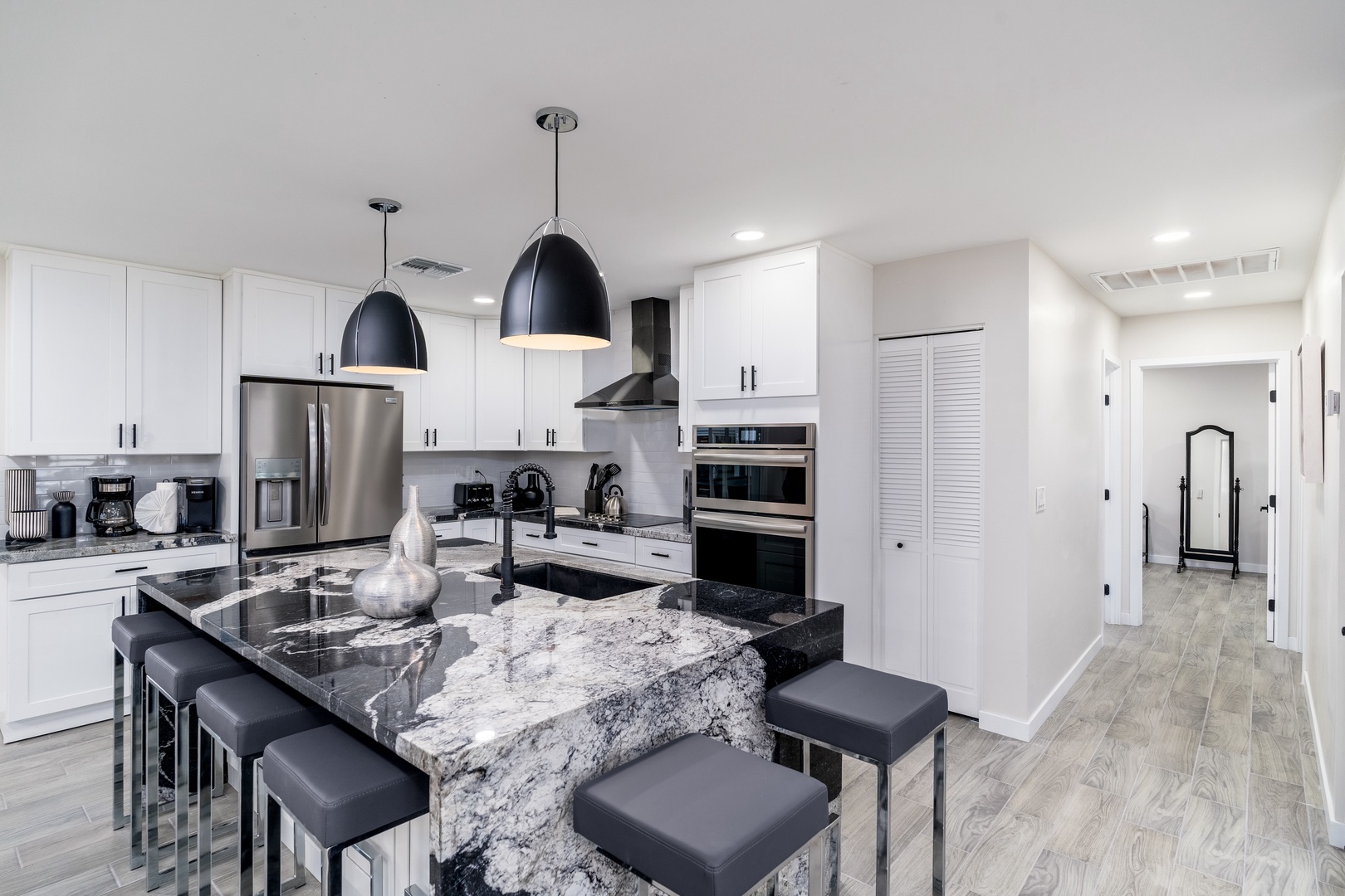 Picture yourself whipping up meals in this stunning gourmet kitchen with marble countertops, stainless steel appliances, and pendant lighting—your home away from home.