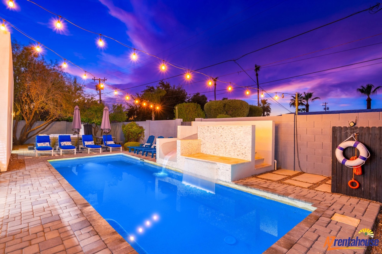 Unwind in your private pool oasis as string lights create magical ambiance overhead, perfect for evening swims under the stars.