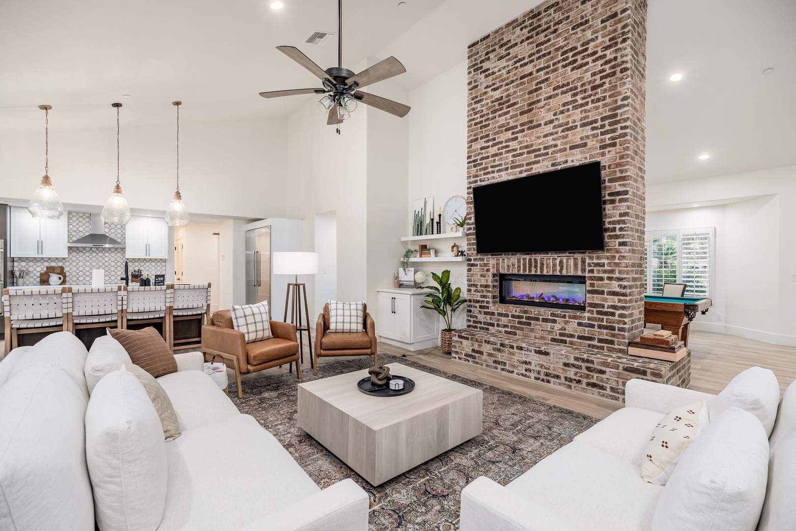 Unwind in your spacious living area, where plush seating and a cozy brick fireplace create the perfect spot to relax after a day of adventure.