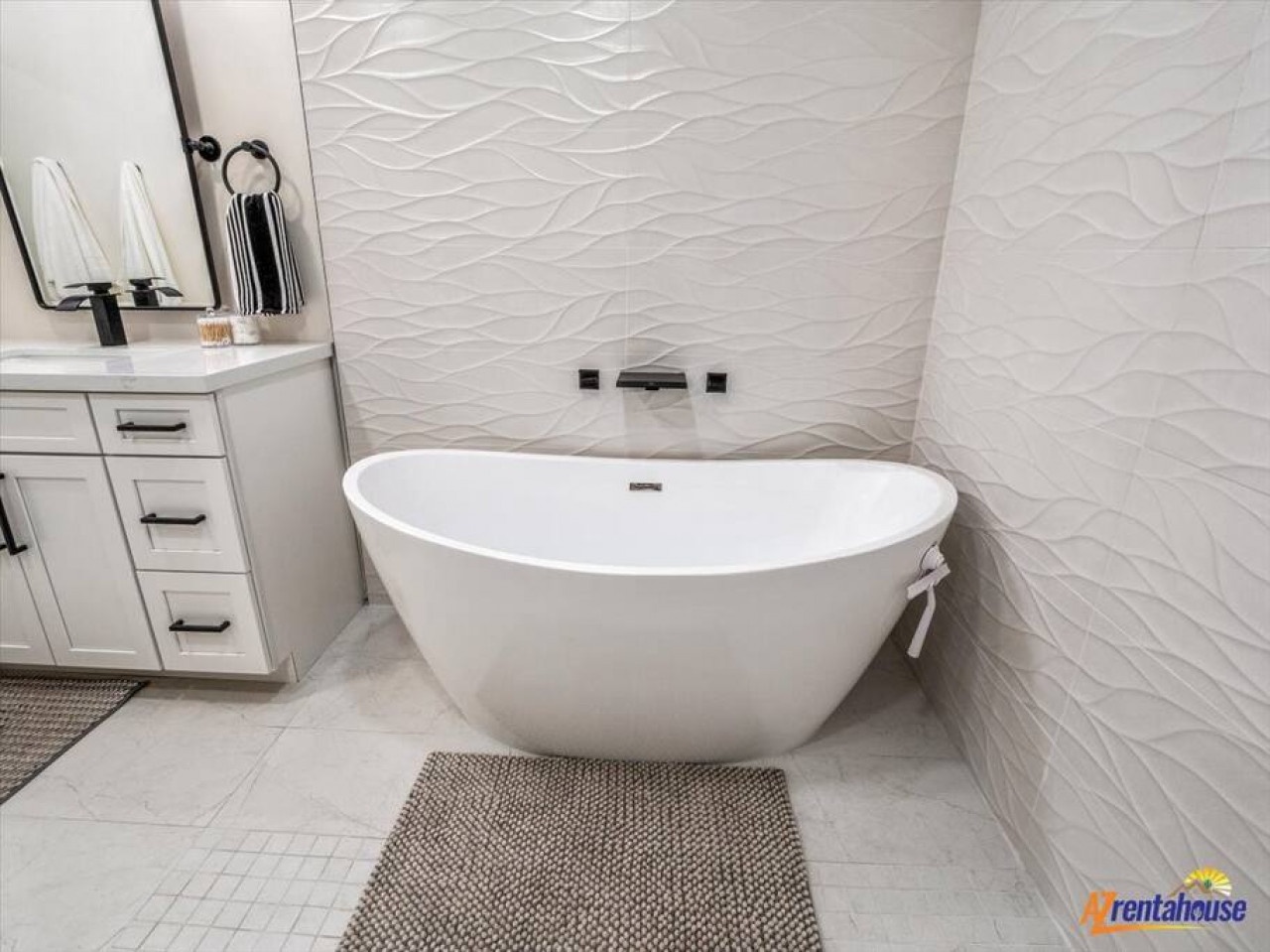 Slip into pure luxury in your elegant soaking tub, surrounded by stunning textured walls and spa-like ambiance.