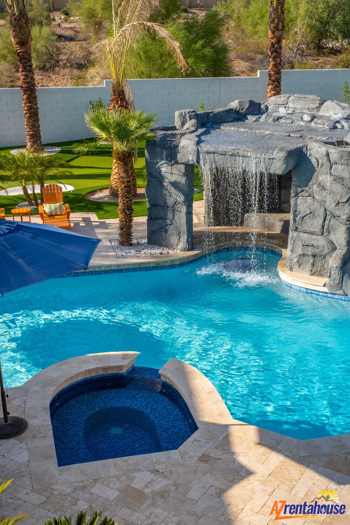 Dive into your private oasis with a stunning stone waterfall cascading into crystal-clear waters, while you soak in the adjacent spa.