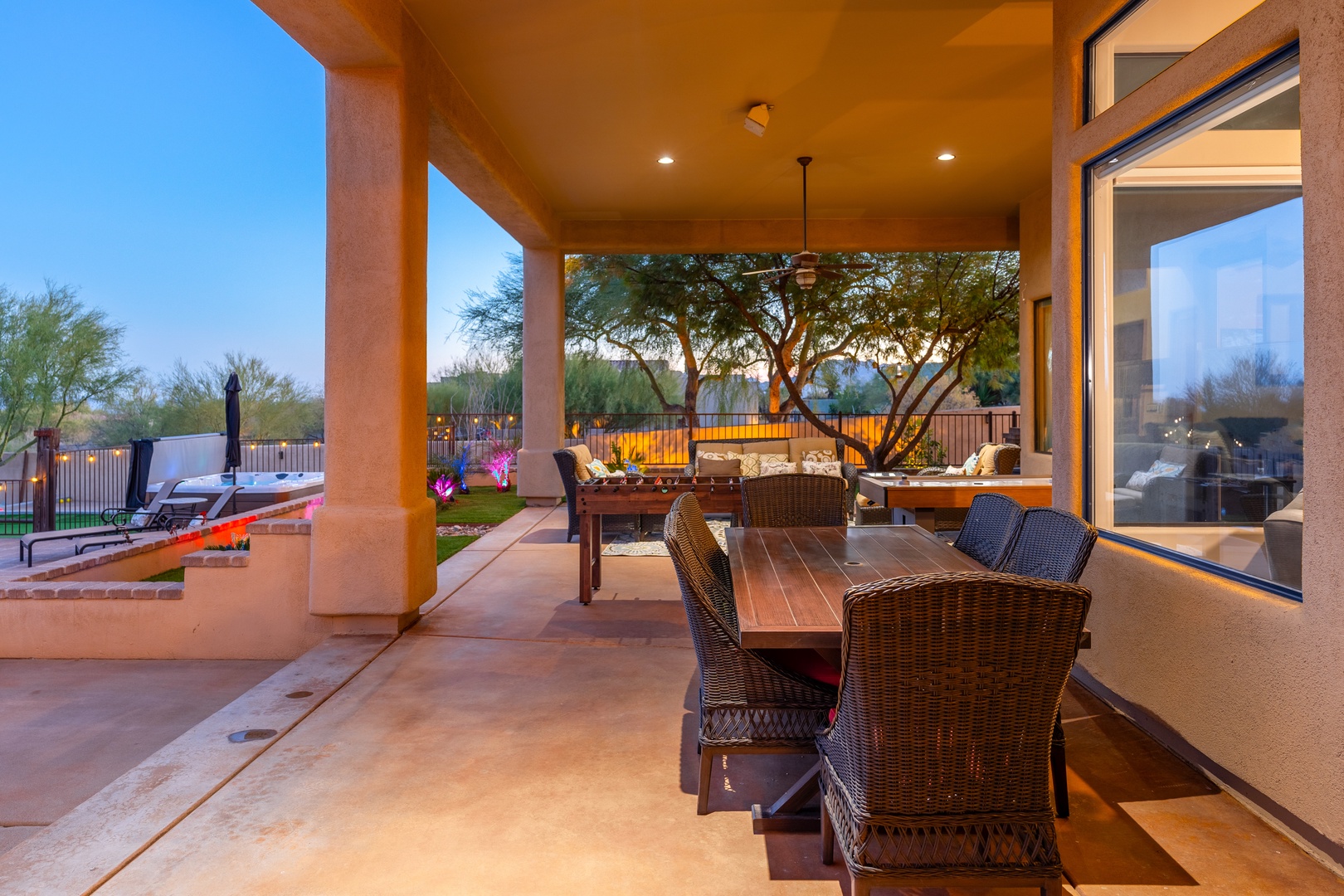 Dine under the stars on your private covered patio, where desert breezes meet warm lighting and inviting outdoor furniture, creating the perfect setting for memorable meals with friends and family.