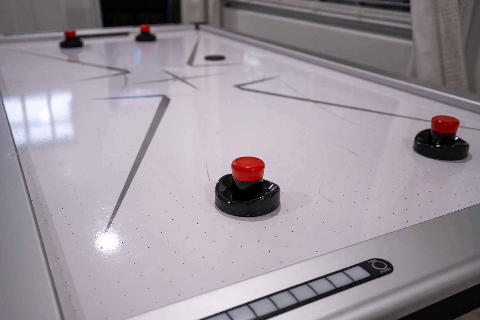 Challenge your friends to a fast-paced game of air hockey on this sleek table—perfect for evenings filled with laughter and friendly competition.