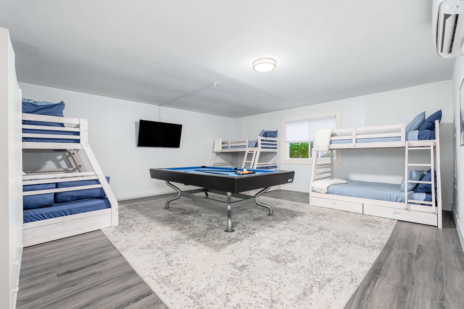 Your group will love this bright bunk room where everyone can gather for games around the pool table or unwind on cozy beds after a day of adventure.