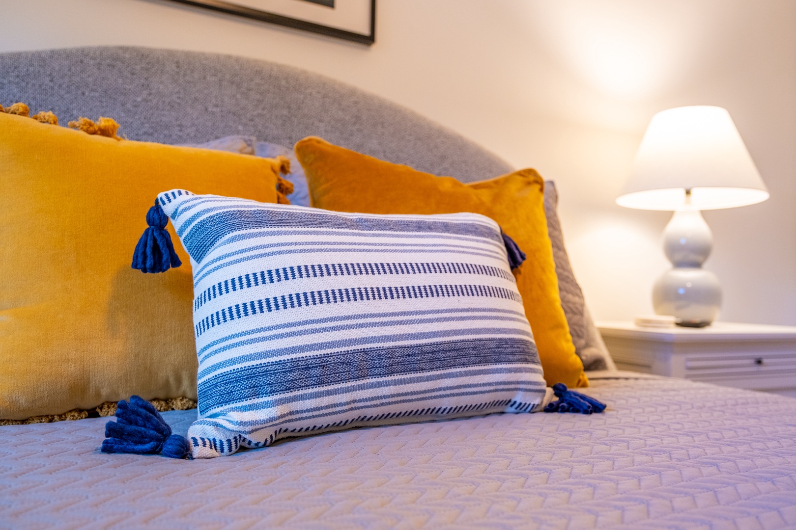 Sink into plush comfort with thoughtfully styled bedding, inviting textures, and a warm bedside glow that makes you feel right at home.