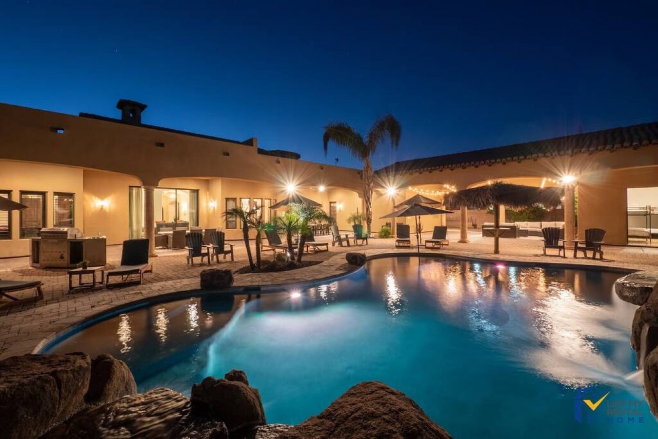 Luxurious desert villa with stunning pool area perfect for evening relaxation under starlit skies.