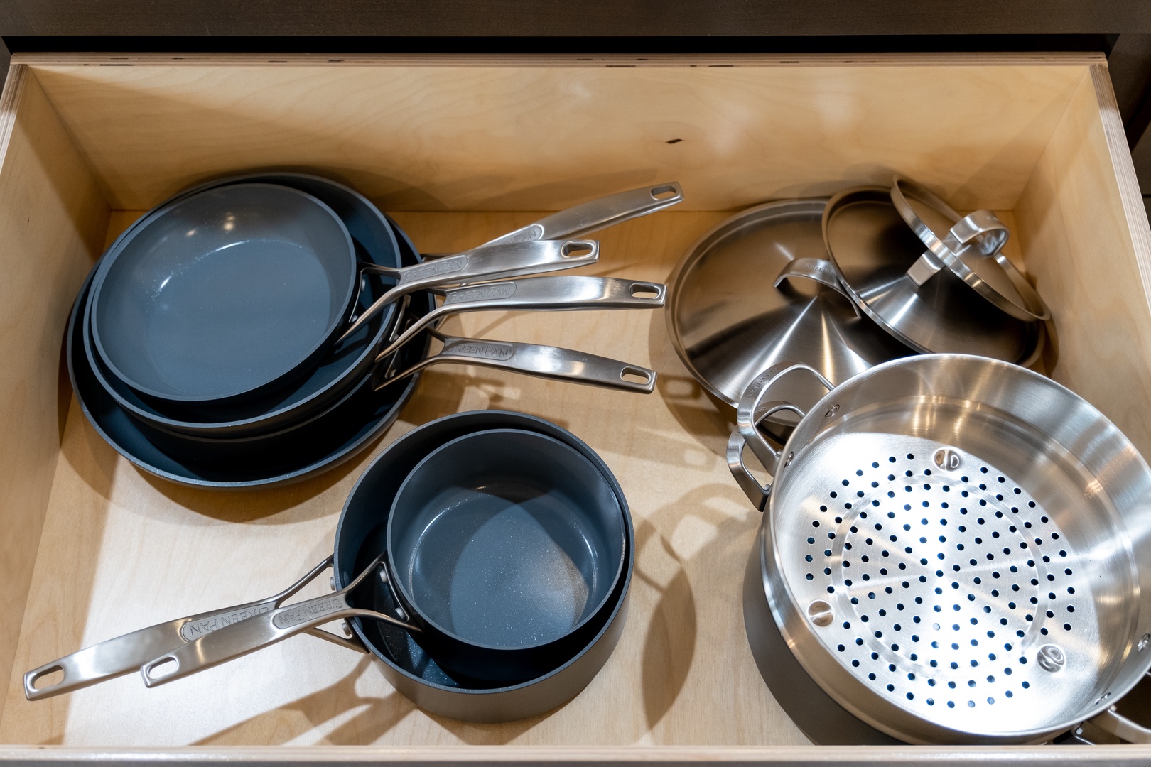 Everything you need to cook your favorite meals—quality cookware including pots, pans, and a steamer basket neatly organized in your kitchen drawer.