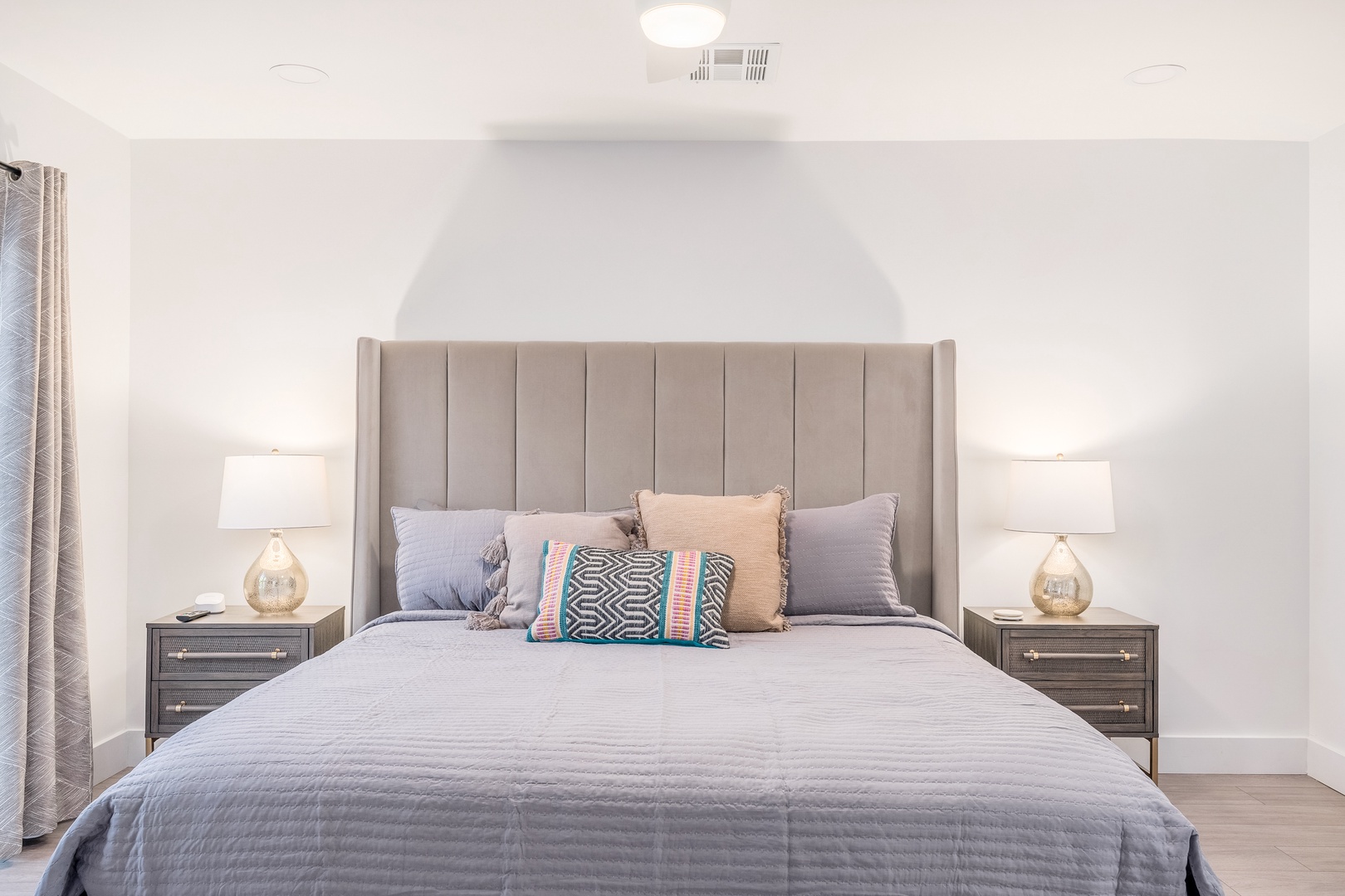 Your restful bedroom features a plush upholstered headboard, soft bedding, and matching bedside lamps—designed to help you unwind after exploring the area.