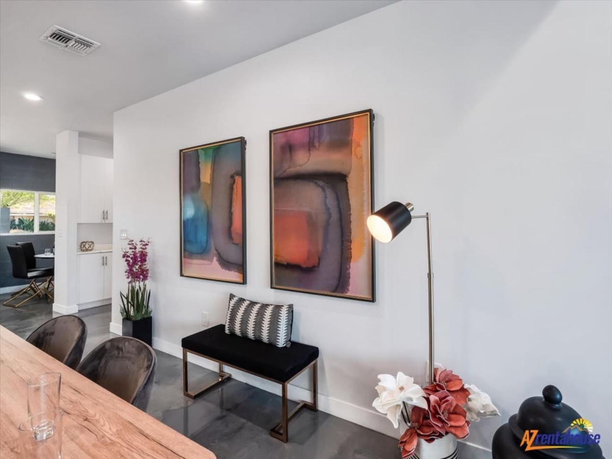 Unwind in your stylish living space where vibrant artwork and thoughtful lighting create the perfect atmosphere for relaxing after your adventures.