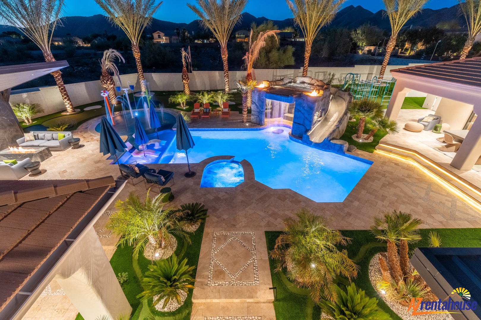 Spectacular resort-style pool area with waterslides and tropical landscaping creates the ultimate backyard oasis for unforgettable evenings.