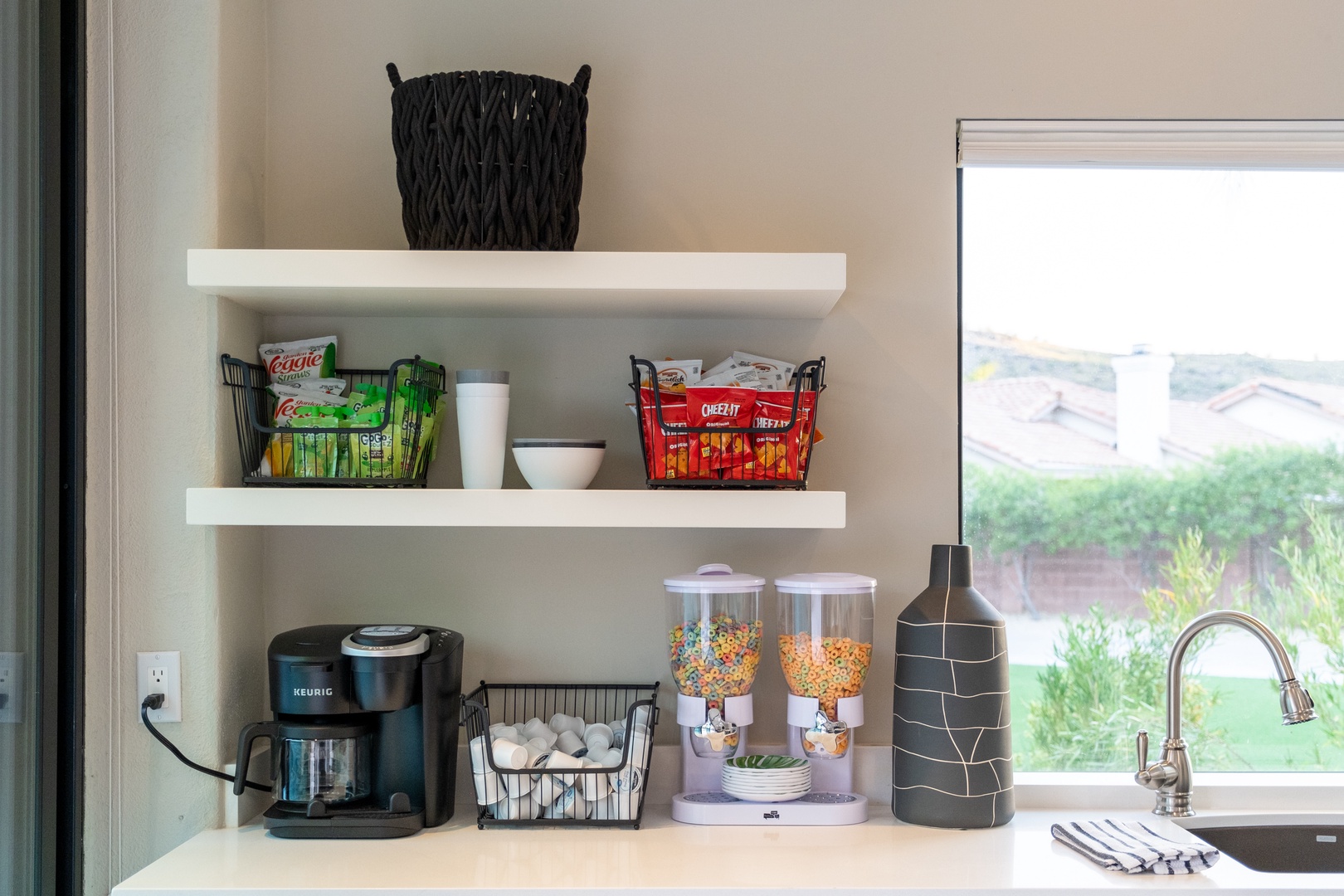 Your own coffee and snack station awaits, stocked with treats and a Keurig to start your mornings right, all framed by peaceful garden views.