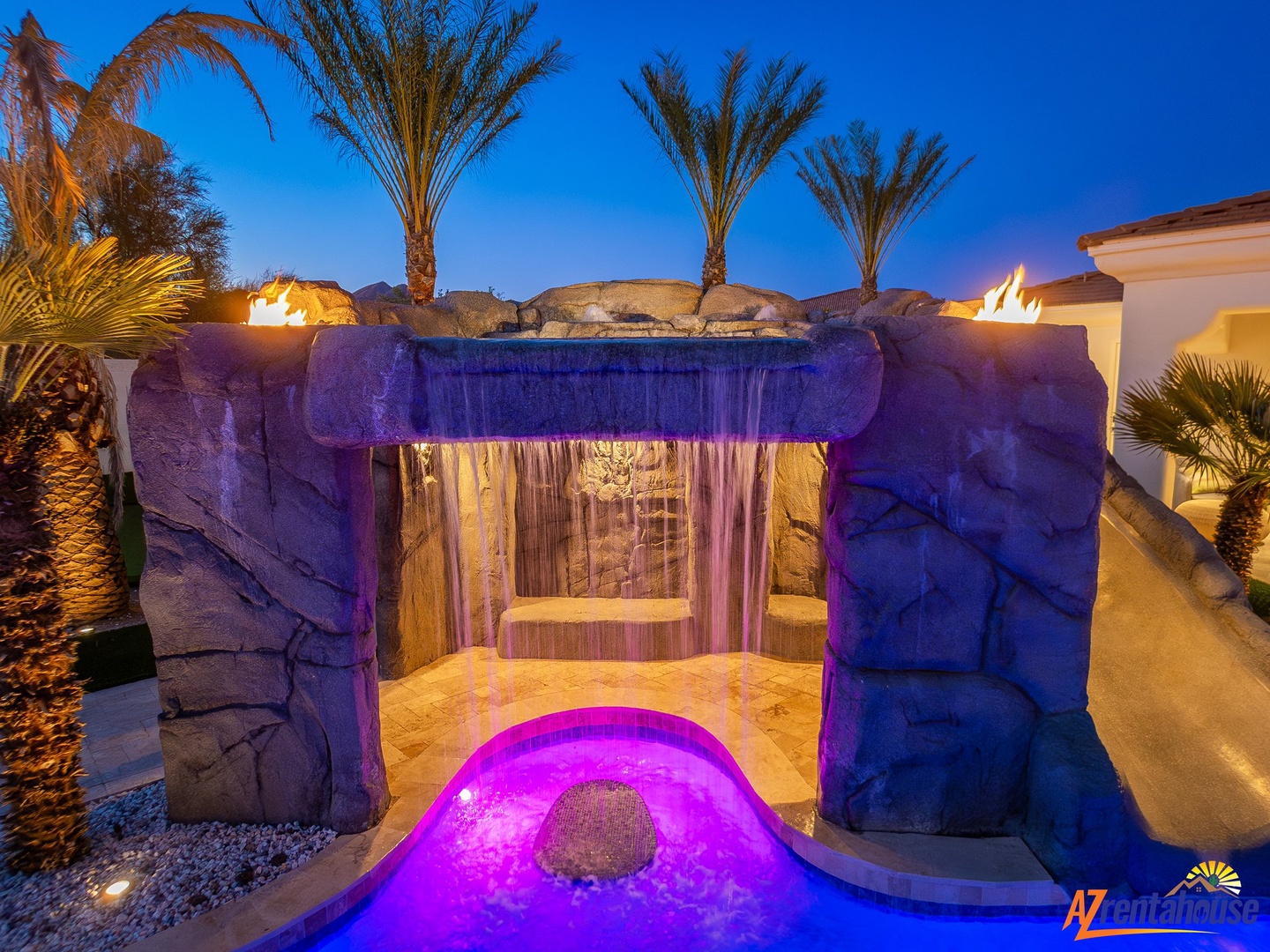 Soak in your illuminated grotto spa as warm water cascades around you, creating the perfect evening retreat.