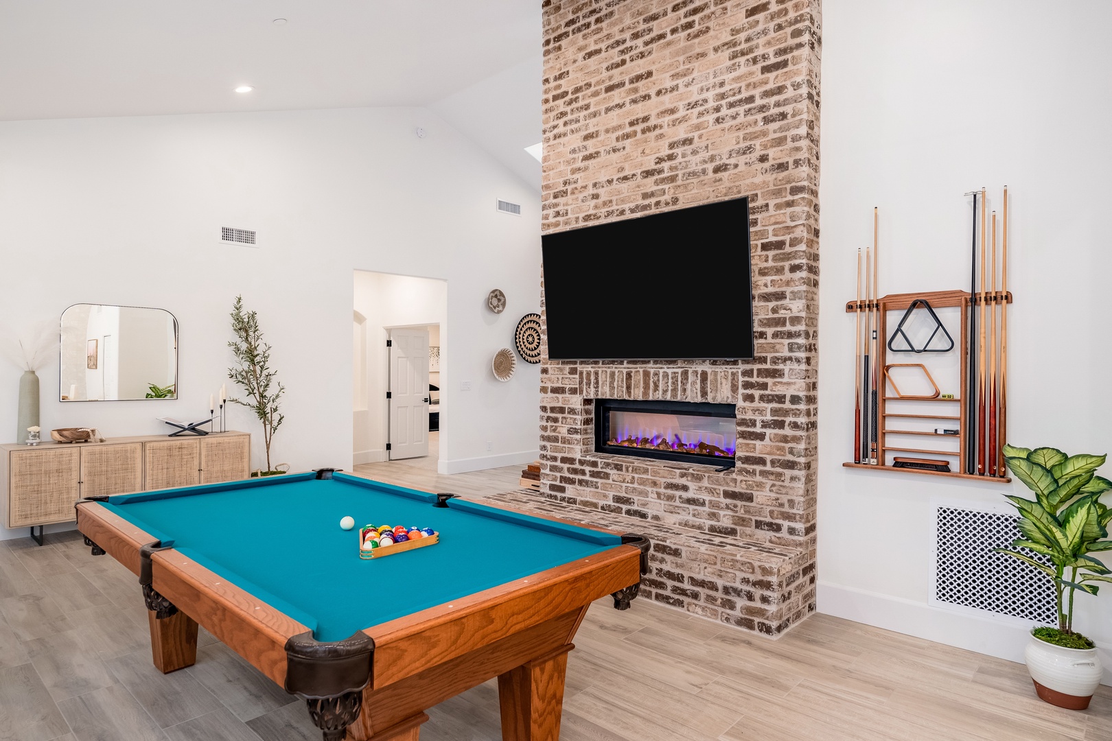 Enjoy evenings in your game room with a pool table, exposed brick fireplace, and flat-screen TV—perfect for unwinding with friends and family.