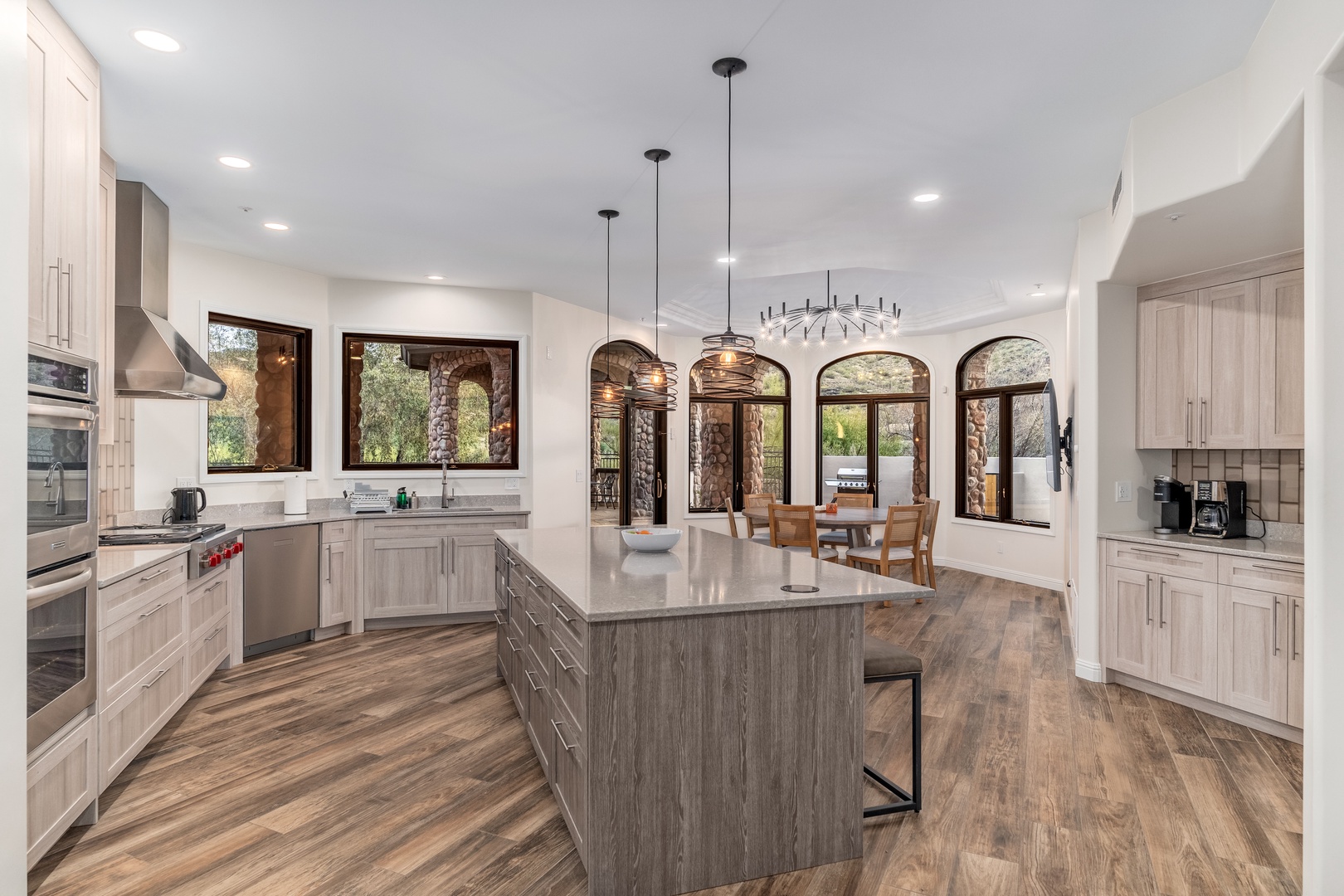 Your dream kitchen awaits—spacious counters, modern appliances, and stunning views through arched windows. Gather around the island or dine with natural light streaming in.