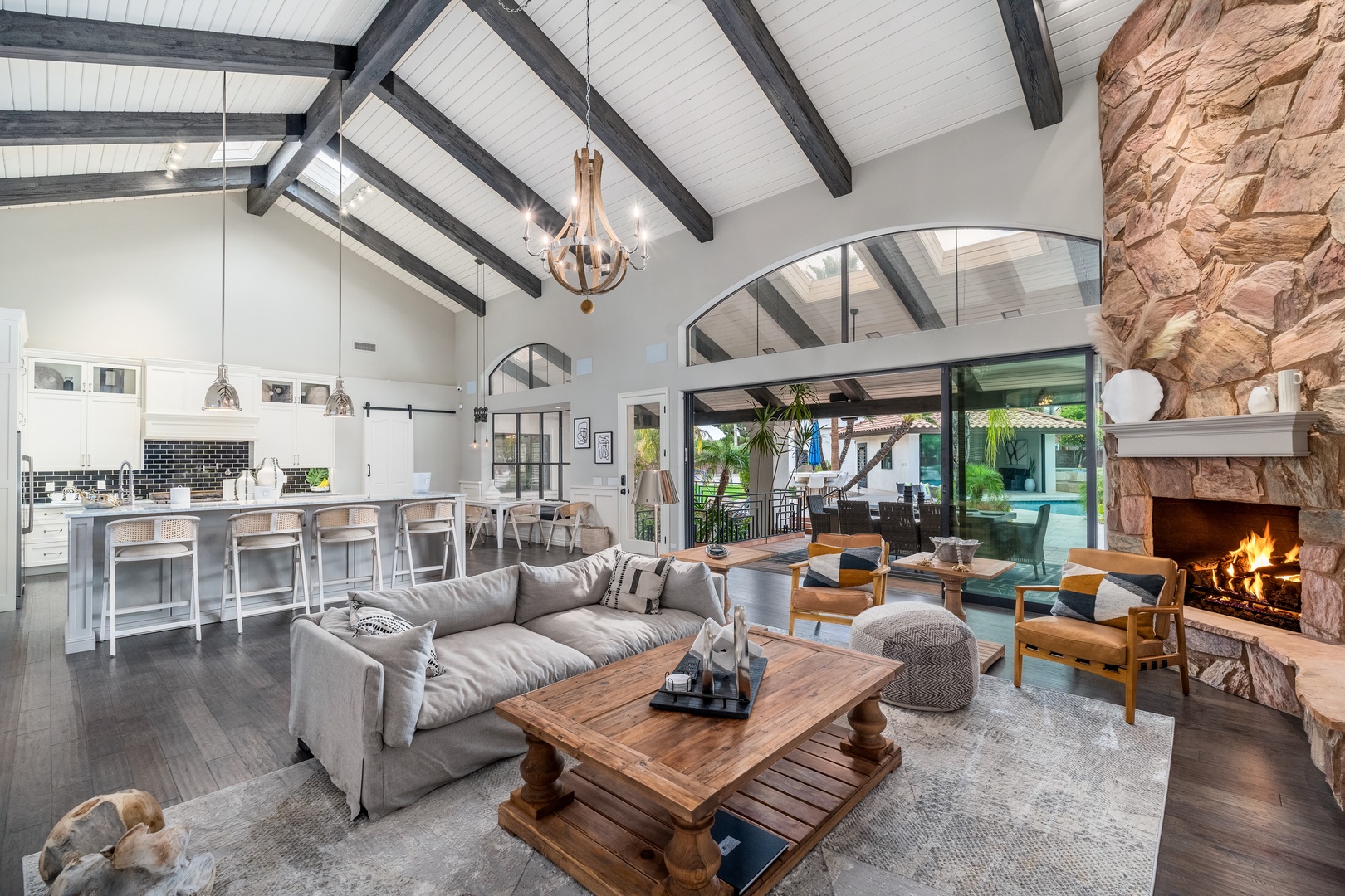 Sink into the plush sofa by the glowing fireplace, unwind in the open kitchen with stunning views, and enjoy your perfect retreat under soaring beamed ceilings.
