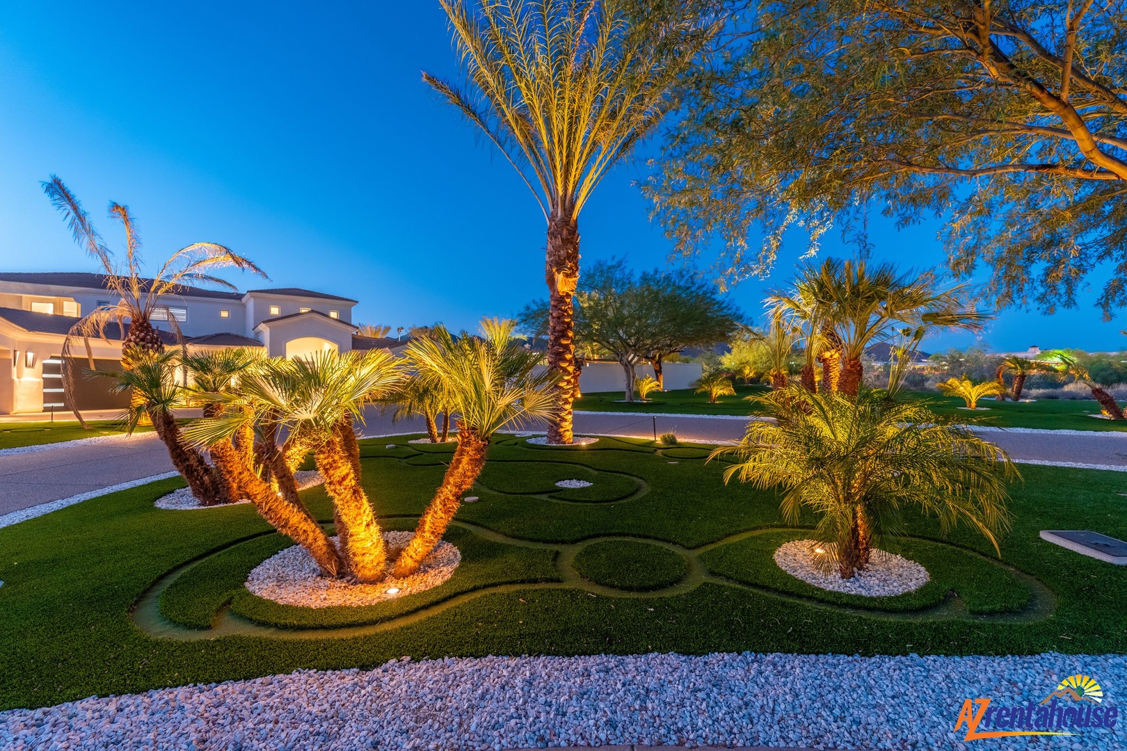 Luxurious landscaped property featuring elegant palm trees and artistic garden design in a beautiful upscale neighborhood.