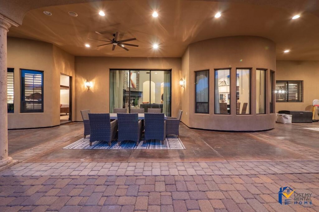 Relax under the stars on your private covered patio, where warm lighting creates the perfect ambiance for outdoor dining and memorable evenings.