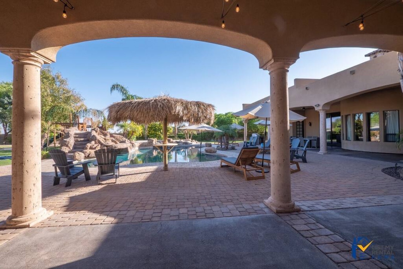Step into your covered patio retreat with stunning views of the sparkling pool and tropical tiki bar.