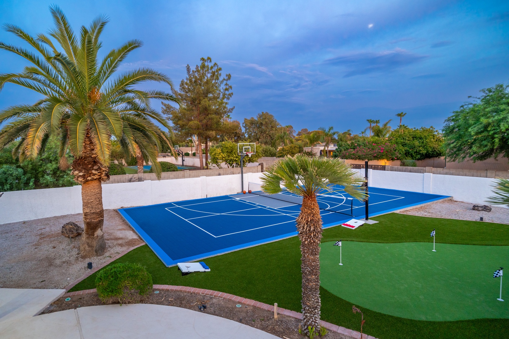 Private sports court and putting green surrounded by palm trees and mountain views. Perfect for friendly games under desert skies.