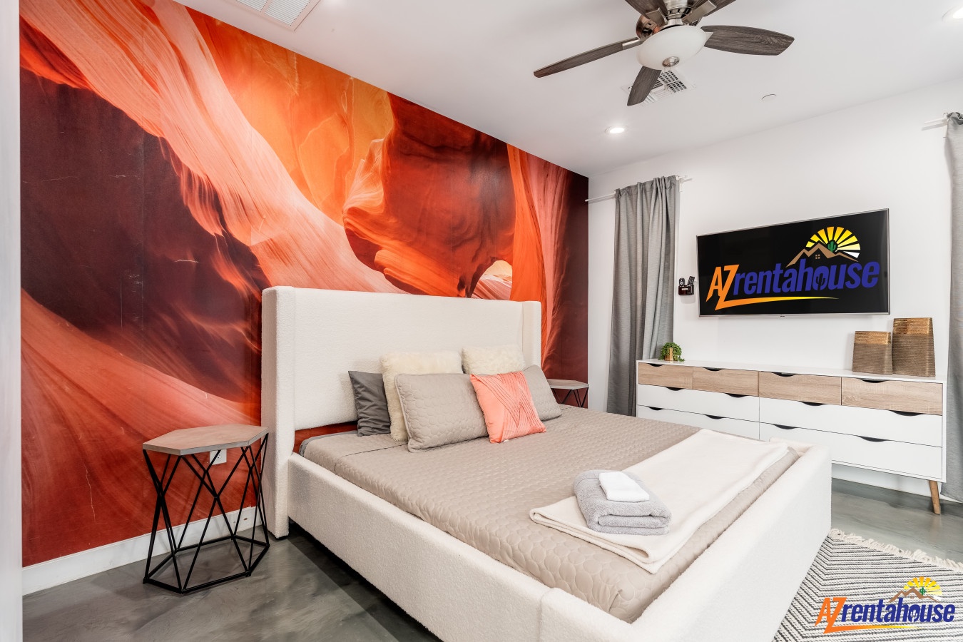Your serene bedroom features a stunning canyon wall mural and modern amenities for the perfect desert-inspired retreat.