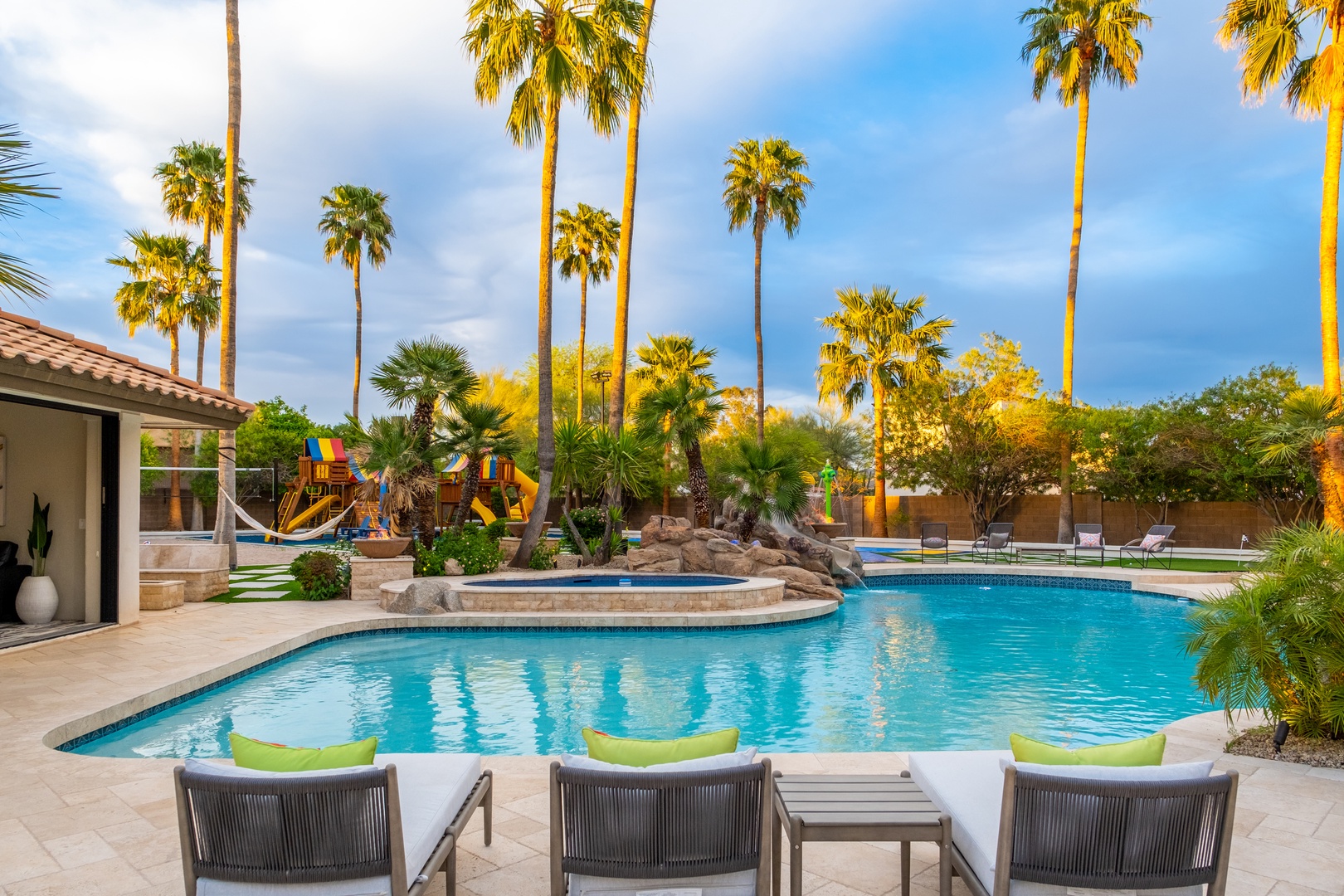 Lounge poolside beneath swaying palms, where your private oasis invites sun-soaked relaxation and refreshing swims against a stunning desert backdrop.