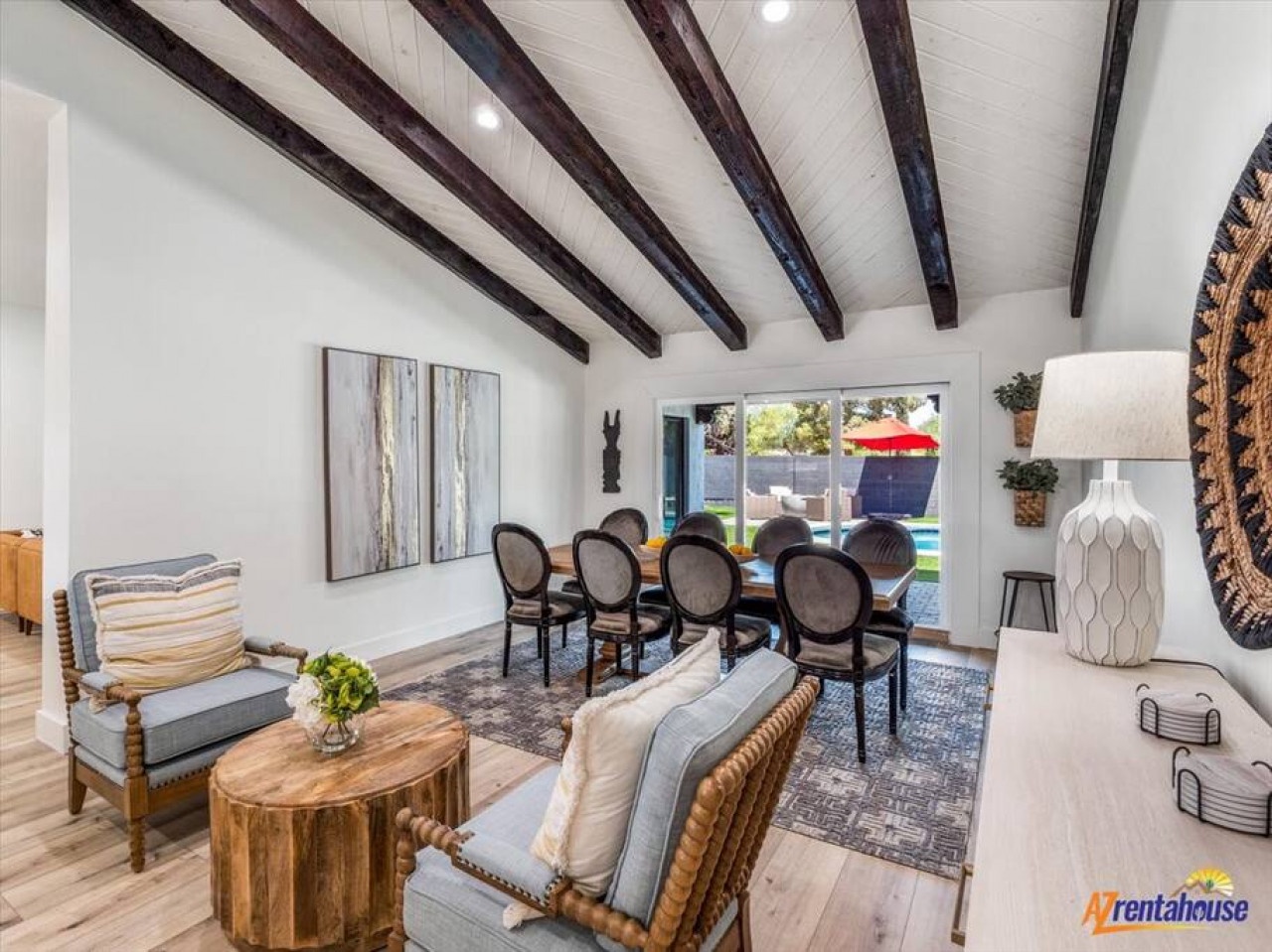 Relax in your elegant living space where exposed beams meet modern comfort, perfect for gathering around the dining table or unwinding in style.