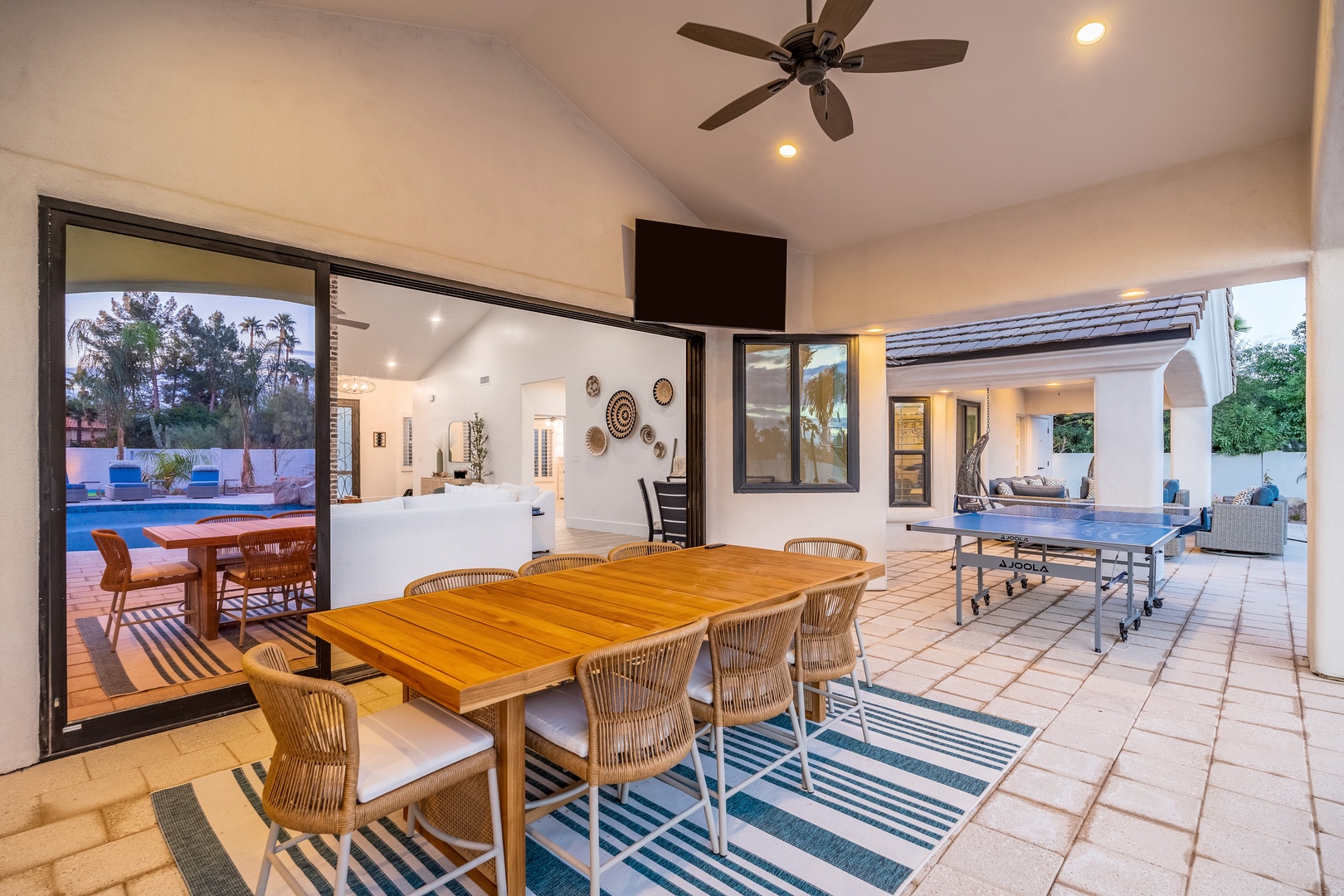 Dine under the stars in this breezy covered patio—your perfect blend of indoor comfort and open-air relaxation, overlooking the sparkling pool.