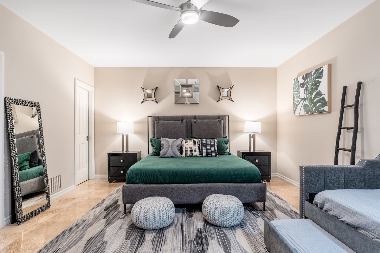 Step into your serene retreat with vaulted ceilings, a plush king bed dressed in emerald linens, and thoughtful touches like a cozy seating area and full-length mirror—your perfect haven for rest and relaxation.