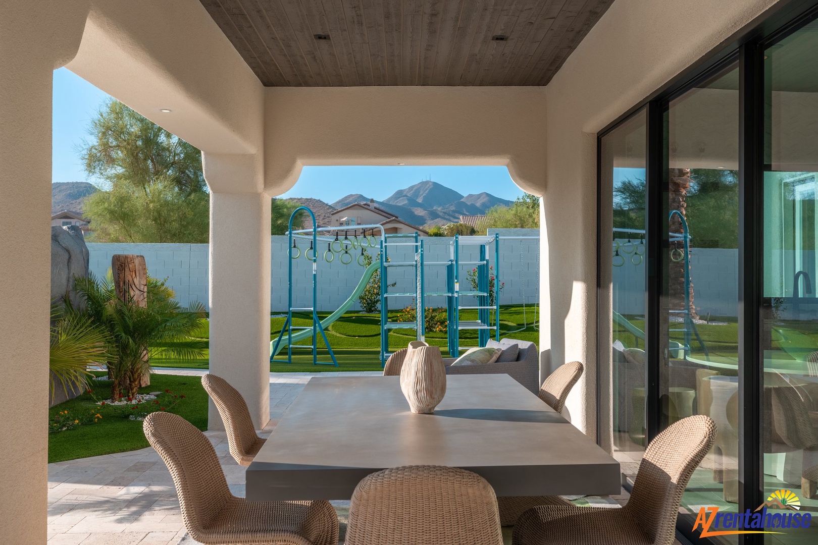Your covered patio offers stylish outdoor dining with stunning mountain views and a playground for the kids.