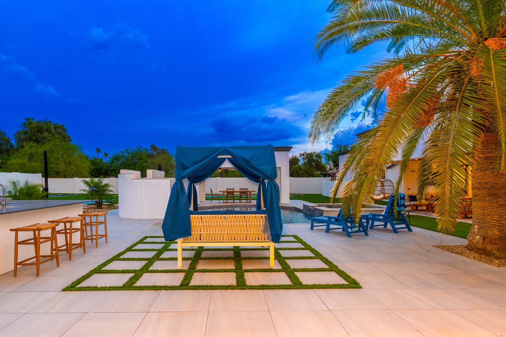 Retreat to your private oasis with a poolside cabana, loungers under swaying palms, and a spacious patio perfect for evening gatherings beneath vibrant desert skies.