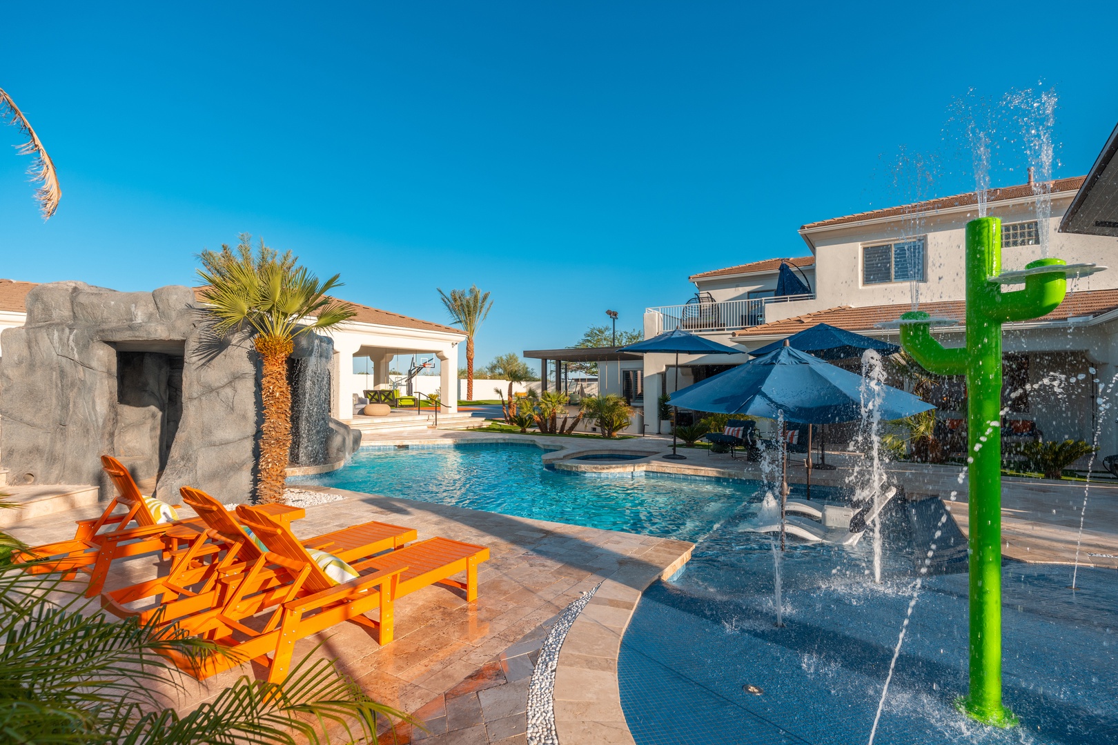 A vibrant desert oasis awaits with sparkling pools, playful fountains, and sunny loungers—your perfect backdrop for fun-filled days under endless blue skies.